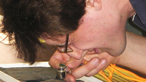 Teacher using a magnifying glass.