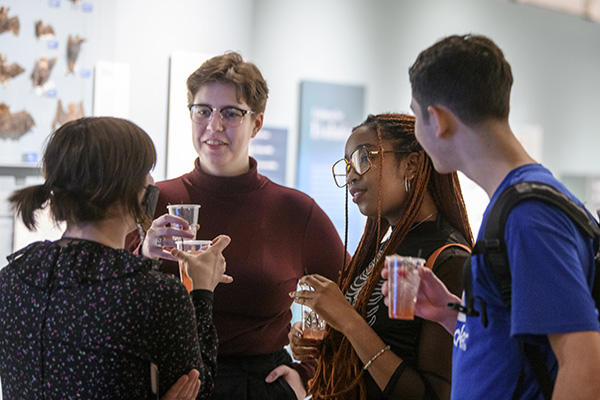 A diverse group of college students chatting in the gallery.