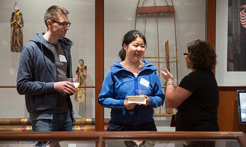 Three diverse people talking in a gallery.