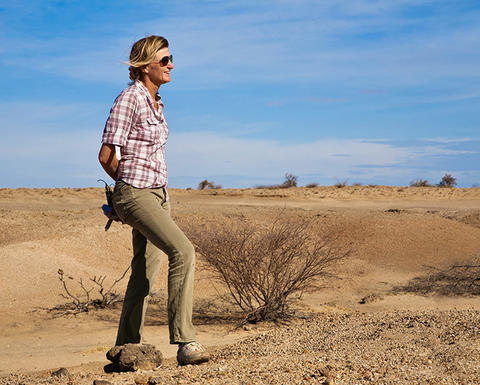 leakey in work clothes outdoors.