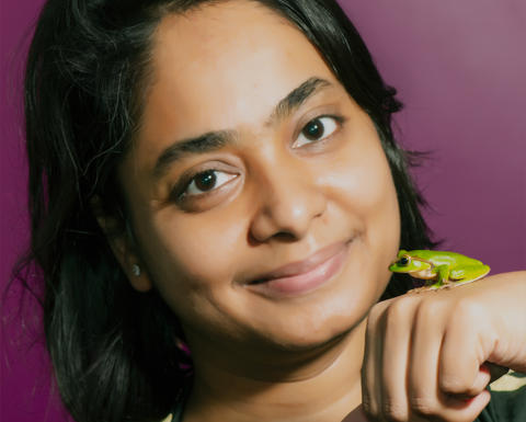 A headshot of speaker Sonali Garg holding a frog.